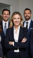 A businessfocused team portrait featuring a mature smiling woman working collaboratively alongside her colleagues within an office setting photo