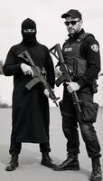 Armed terrorist with an AK47 faces off against masked special forces operative both armed and in combat attire photo