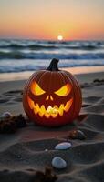 Jack O Lantern adorned with eerie features atop the sandy shoreline beach setting photo