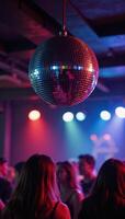 Club party atmosphere featuring a sparkling disco ball shining and glowing among colorful lights photo