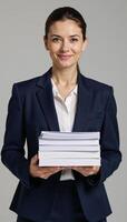 Image features a mature businesswoman clutching documents in a professional setting photo