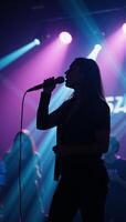 Dynamic neoncolored karaoke performance silhouetted onstage with electric energy and vibrant pulsing lights photo