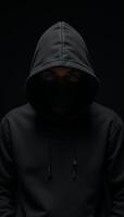 Computer Hacker Blackhooded figure in Dark Moody Background photo