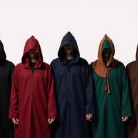 A line of robed figures with hoods gathers together photo