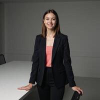 Businesswoman poses confidently in corporate setting gazing directly into camera lens photo