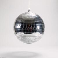 A discoball sphere glows brightly against a pristine white backdrop photo