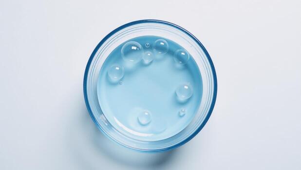 Top view of bubbly water in a blue basin against a white backdrop Isolated photo