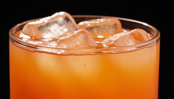 Closeup image of a sparkling orange drink with ice cubes photography photo