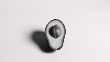 Sketch of half an avocado with pit engraved on scratchboard rendered as blackandwhite raster art photo