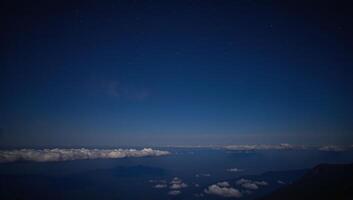 Tranquil starry night over glowing clouds photo