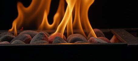 A glowing flaming BBQ grill on a black backdrop Empty hot grate with fiery coals photo