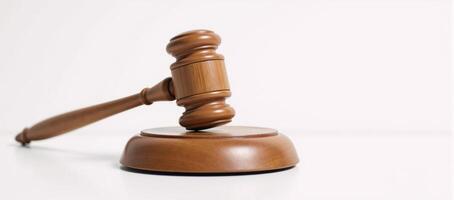 Wooden judges gavel on a plain backdrop embodies power fairness and legal principles photo