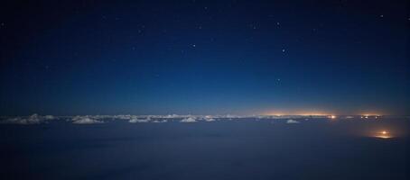 Tranquil starry night over glowing clouds photo