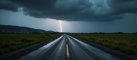 Stormtossed road with distant lightning and ominous clouds photo