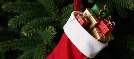 A Christmas scene features a festive redstocking brimming with presents against a green backdrop Green Background Red Stocking Gifts photo