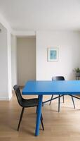A Minimalist Japanese Living Room highlights a Blue Dining Table with Stylish Chairs photo