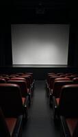 A staged venue featuring rows of empty seats and a large blank screen photo