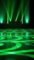 Vibrant dynamic stage setting with green lights and reflective geometric patterns for events or performances photo