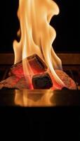 A glowing flaming BBQ grill on a black backdrop Empty hot grate with fiery coals photo
