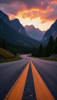 Sunrise panorama over asphalt highway meeting mountainside natural landscape photo