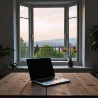 Laptop on wood table with balcony dusk view photo