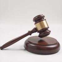Wooden judges gavel on a plain backdrop embodies power fairness and legal principles photo