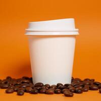 A closeup image showcases a white takeout cup with its lid and roasted coffee beans on an orange background photo