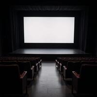 A staged venue featuring rows of empty seats and a large blank screen photo