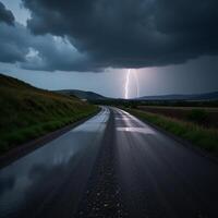 Stormtossed road with distant lightning and ominous clouds photo