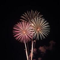 Vibrant firework display against starry backdrop at nighttime photo