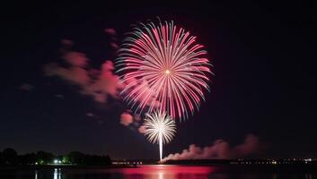 A colorful display of fireworks lighting up the night sky amidst floating clouds photo