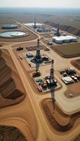 Oil field landscape featuring extraction processing and storage facilities such as drilling sites refineries pipelines and oil tank farms photo