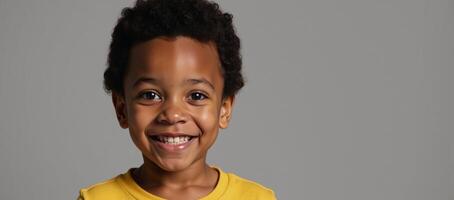 Cute AfricanAmerican boy in yellow shirt with curious bright eyes Afro gazing upward on neutral backdrop photo