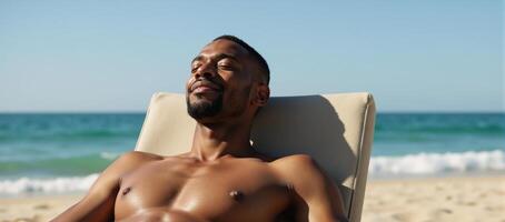 African American man relaxing at the beach with a reclined posture and soaking up the sun photo