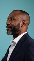 Portrait of a wise confident introspective African American man on calming blue backdrop photo