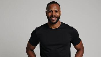A confident AfricanAmerican model showcases the flexibility of a fitted black tee on a neutral backdrop photo