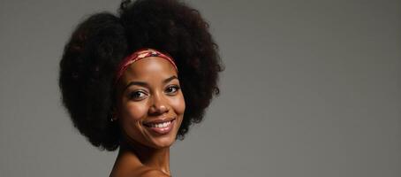 70sinspired portrait featuring an African American woman wearing a retro hairstyle with a large afro and headband photo