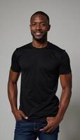 A confident AfricanAmerican model showcases the flexibility of a fitted black tee on a neutral backdrop photo