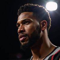 Closeup portrait of an African American basketball player defiant expression lit by a single courtlight photo
