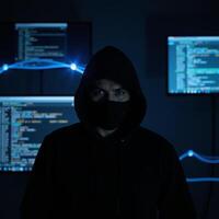 Anonymous hacker embodied as mysterious figure amidst dark web themes on ominous digital backdrop eliciting feelings of intrigue and warning photo