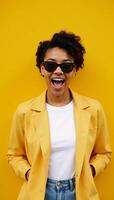 Excited black Gen Z woman with sunnies and shocked expression in front of a brightyellow background promoting summer sales and travels photo
