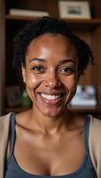 A joyful selfportrait captures a smiling African American woman radiating warmth amidst a cozy home setting Warm Lighting Comfortable Home photo