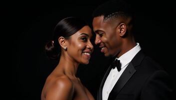 Against a backdrop of pure black an isolated AfricanAmerican couple dates photo