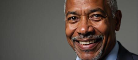 A confident senior man in his sixties smiles in a closeup portrait shot African American photo