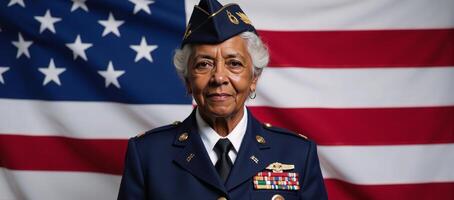 An elderly AfricanAmerican woman veteran stands before an American flag on Veterans Day photo