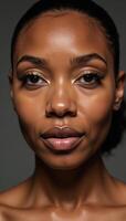 Closeup image featuring an African American woman with intricate golden makeup application photo