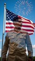 An AfricanAmerican veteran salutes before an American flag in a memorial setting evoking patriotism on Independence Day photo