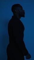 Outline of an AfricanAmerican man in profile against deep blue backdrop photo