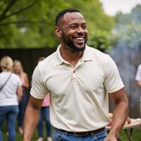 Closeup portrait of an African American man smiling while grilling food at a backyard barbeque photo