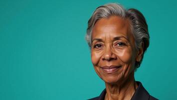Portrait of an elder AfricanAmerican woman against a teal backdrop with ample room for text photo